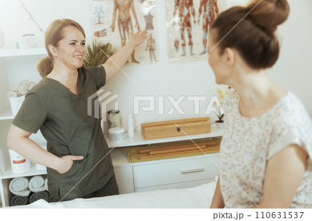 happy female medical massage therapist in massage cabinet 110631537