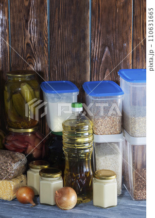 Food supplies for the period of quarantine isolation. Various glass jars with cereals, pasta, cans of canned food Food supplies for the period of quarantine isolation. Various glass jars with cereals, pasta, cans of canned food 110631665