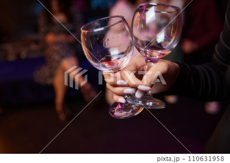 Clinking glasses with alcohol and toasting, party. 110631958