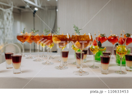 Welcome drink with cocktail glasses and drinks at an event. Alcoholic beverages at a wedding Welcome drink with cocktail glasses and drinks at an event. Alcoholic beverages at a wedding 110633453