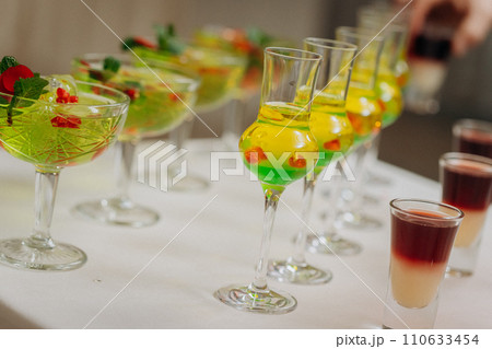 Welcome drink with cocktail glasses and drinks at an event. Alcoholic beverages at a wedding Welcome drink with cocktail glasses and drinks at an event. Alcoholic beverages at a wedding 110633454