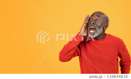 Joyful elderly man in a red sweater loudly sharing exciting news or gossip, hand to mouth 110634610