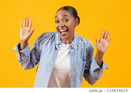 Excited black lady showing palms hands gesturing to camera, studio Excited black lady showing palms hands gesturing to camera, studio 110634624