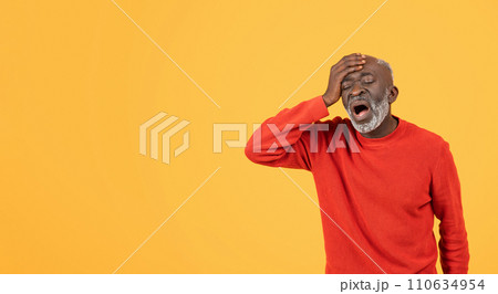 Elderly man in red sweater and hat holding his head with an agonized expression Elderly man in red sweater and hat holding his head with an agonized expression 110634954