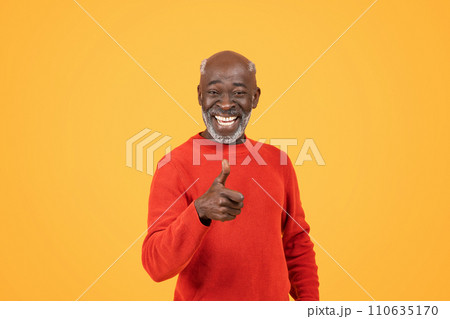 Smiling senior man with a vibrant personality gives a thumbs-up sign 110635170