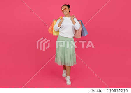 Happy Asian Woman Walking With Shopping Bags In Hands On Pink Background 110635216