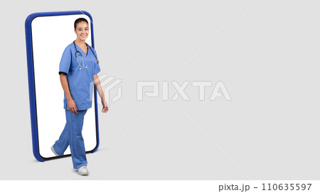 European medical professional in blue scrubs stepping out from a smartphone screen European medical professional in blue scrubs stepping out from a smartphone screen 110635597