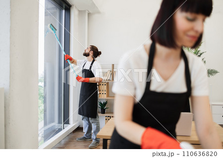 Multinational group cleans bright office. 110636820
