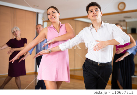 Young pair practicing Latino dance in dance studio Young pair practicing Latino dance in dance studio 110637513