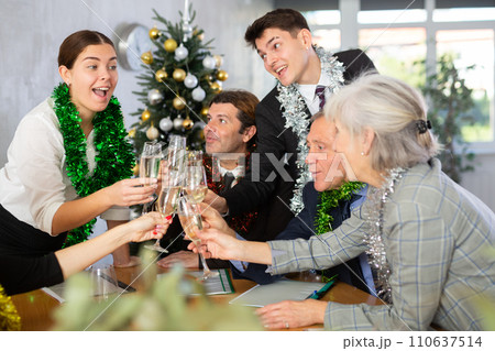 Portrait of professional business team delighted with achievements of joint work on eve of Christmas Portrait of professional business team delighted with achievements of joint work on eve of Christmas 110637514