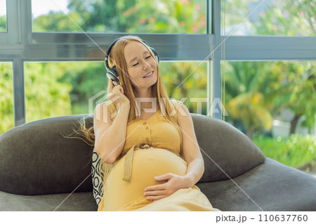 Expectant mom finds joy in her pregnancy, listening to soothing music for a serene and harmonious connection with her unborn baby Expectant mom finds joy in her pregnancy, listening to soothing music for a serene and harmonious connection with her unborn baby 110637760