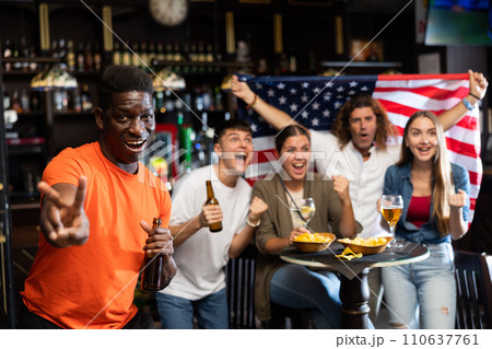 American football team fan spending time in bar 110637761