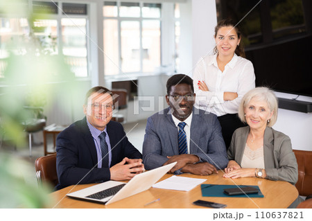 Group of different people posing at table in office 110637821