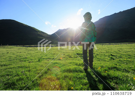 Woman enjoy the view on high altitude grassland 110638719