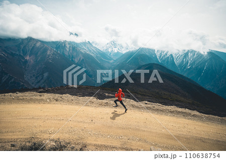 Woman trail runner cross country running at high altitude mountains 110638754
