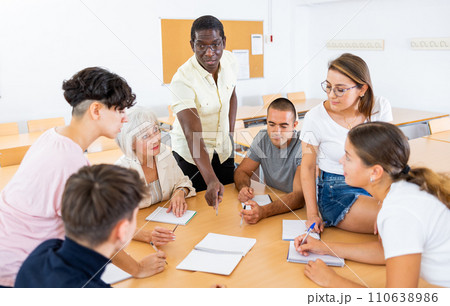 People of different ages communicating in speaking club with African American teacher People of different ages communicating in speaking club with African American teacher 110638986