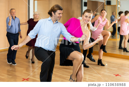 Happy couple performing a paired dance in ballroom 110638988