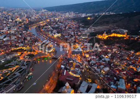 Night aerial view of Tbilisi city with Kura river 110639017