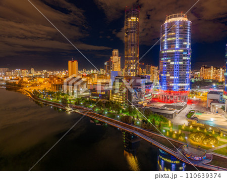 Yekaterinburg city and pond aerial panoramic view at summer or early autumn night. Night city in the early autumn or summer. Yekaterinburg city and pond aerial panoramic view at summer or early autumn night. Night city in the early autumn or summer. 110639374