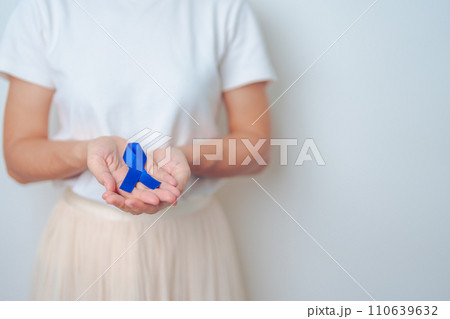 March Colorectal Cancer Awareness month, doctor with dark Blue Ribbon for supporting people living and illness. Healthcare, hope and World cancer day concept 110639632