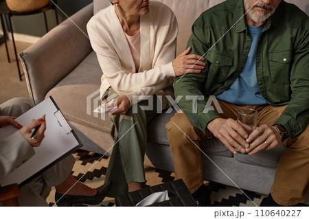 High angle closeup of adult couple supporting each other in couples therapy session, copy space High angle closeup of adult couple supporting each other in couples therapy session, copy space 110640227