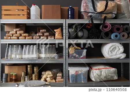 Graphic background image of stacked shelves with food and supplies in warehouse pf refugee help center, copy space Graphic background image of stacked shelves with food and supplies in warehouse pf refugee help center, copy space 110640508