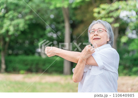 公園で運動・体操・ストレッチする高齢者女性 110640985