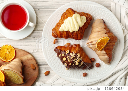 Fresh croissants with cup of tea on table 110642084