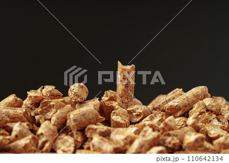 Heap of wood pellets biofuel on black background Heap of wood pellets biofuel on black background 110642134