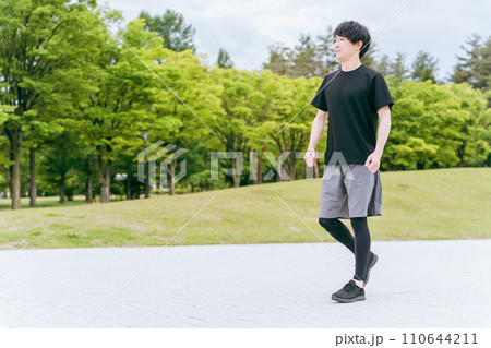 公園を歩く・ウォーキングする男性・スポーツマン・アスリート（全身） 110644211
