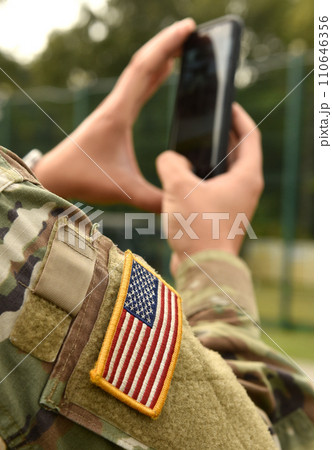 US soldier make a photo on his smartphone US soldier make a photo on his smartphone 110646356