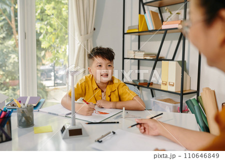 Excited kid drawing planet in class after learning about renewable energy sources 110646849