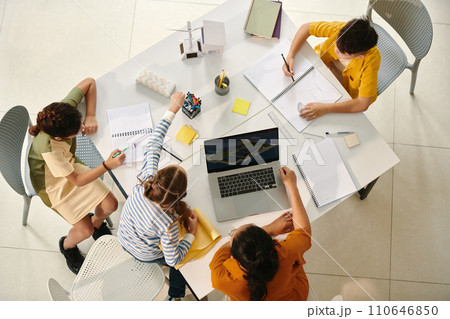 Group of school kids drawing future towns which use renewable energy recourses 110646850