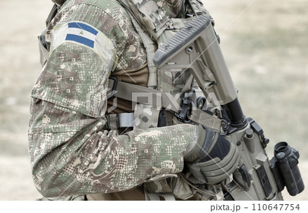 Soldier with assault rifle and flag of Nicaragua on military uniform. Collage. Soldier with assault rifle and flag of Nicaragua on military uniform. Collage. 110647754