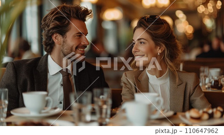 elegant business couple sitting in luxury restaurant with glass of shampagne 110647962