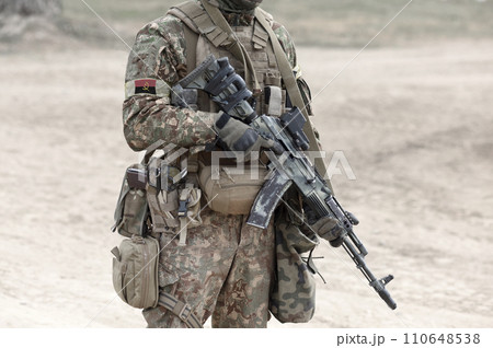 Soldier with assault rifle and flag of Angola on military uniform. Collage. Soldier with assault rifle and flag of Angola on military uniform. Collage. 110648538