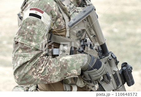 Soldier with assault rifle and flag of Egypt on military uniform. Collage. 110648572