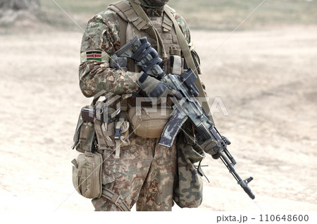 Soldier with assault rifle and flag of Kenya on military uniform. Collage. 110648600