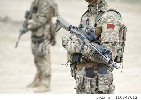 Soldiers with assault rifle and flag of Morocco on military uniform. Collage. 110648612