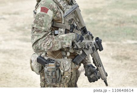 Soldier with assault rifle and flag of Morocco on military uniform. Collage. Soldier with assault rifle and flag of Morocco on military uniform. Collage. 110648614