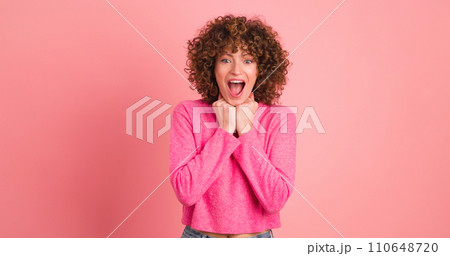 Stunned young woman standing with opened mouth on pink background Stunned young woman standing with opened mouth on pink background 110648720