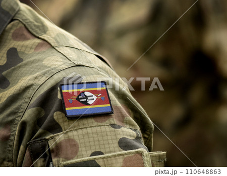 Eswatini, also known as Swaziland flag on soldiers arm. Kingdom of Eswatini flag on military uniform. Army, troops, military, Africa (collage). Eswatini, also known as Swaziland flag on soldiers arm. Kingdom of Eswatini flag on military uniform. Army, troops, military, Africa (collage). 110648863