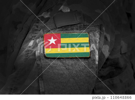 Flag of Togo on military uniform. Army, troops, soldiers. Collage. Flag of Togo on military uniform. Army, troops, soldiers. Collage. 110648866