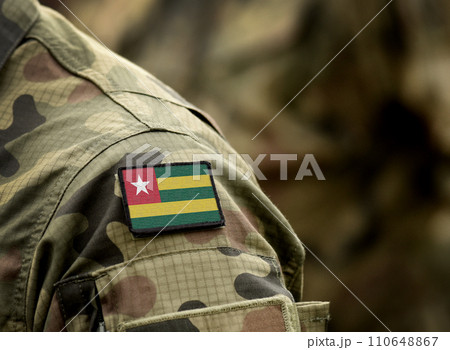 Flag of Togo on military uniform. Army, troops, soldiers. Collage. Flag of Togo on military uniform. Army, troops, soldiers. Collage. 110648867
