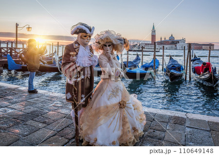 Colorful carnival masks at a traditional festival in Venice against gondolas, Italy Colorful carnival masks at a traditional festival in Venice against gondolas, Italy 110649148