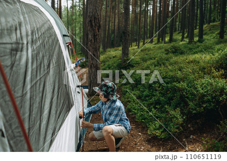 cute little caucasian boy putting up a tent. Family camping concept cute little caucasian boy putting up a tent. Family camping concept 110651119