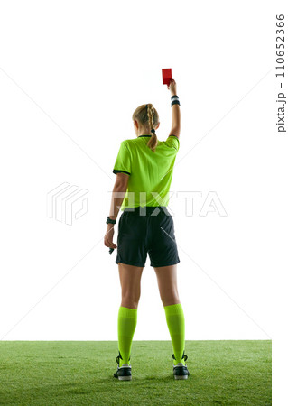Serious woman, soccer referee gesturing, raising hand, stopping game and showing red card against white studio background 110652366