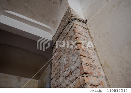 Building interior with red brick prepared for renovation. Real photo. 110652513