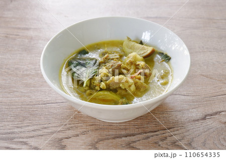 spicy boiled slice beef meat with eggplant in coconut milk green curry soup on bowl 110654335