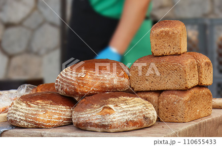 Loaves of sourdough bread and cubes of rye bread. 110655433
